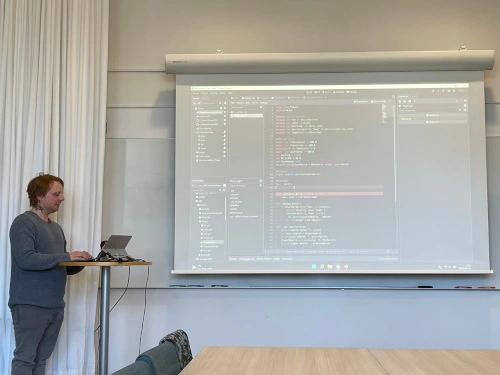 Employee presenting Godot, facing projector screen